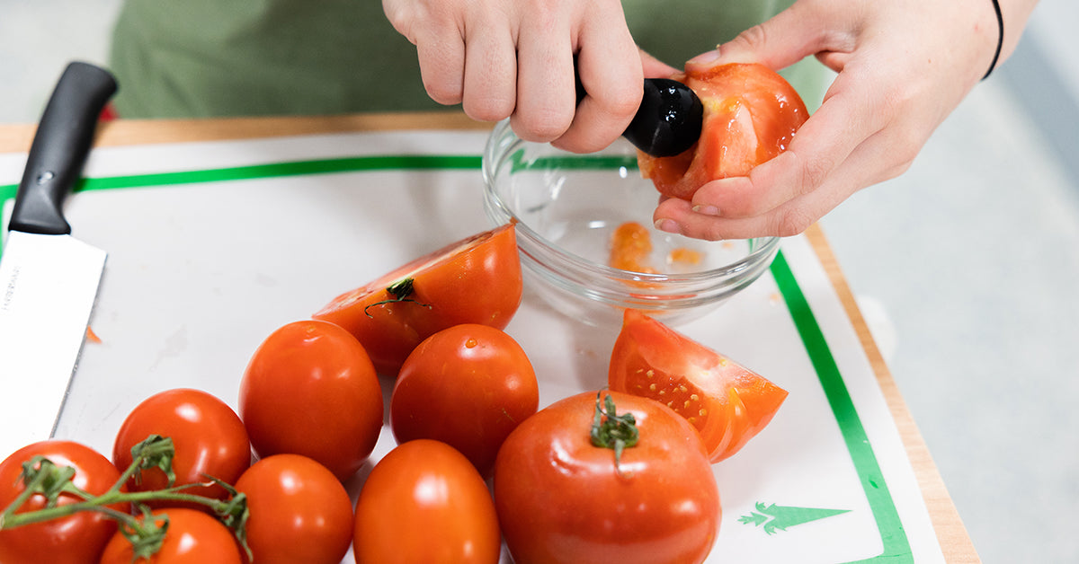 scooping out tomato seeds