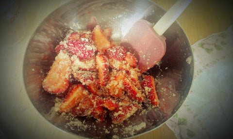 Sliced Strawberries with Sugar in a Stainless Bowl Mashed with Rubber Spatula