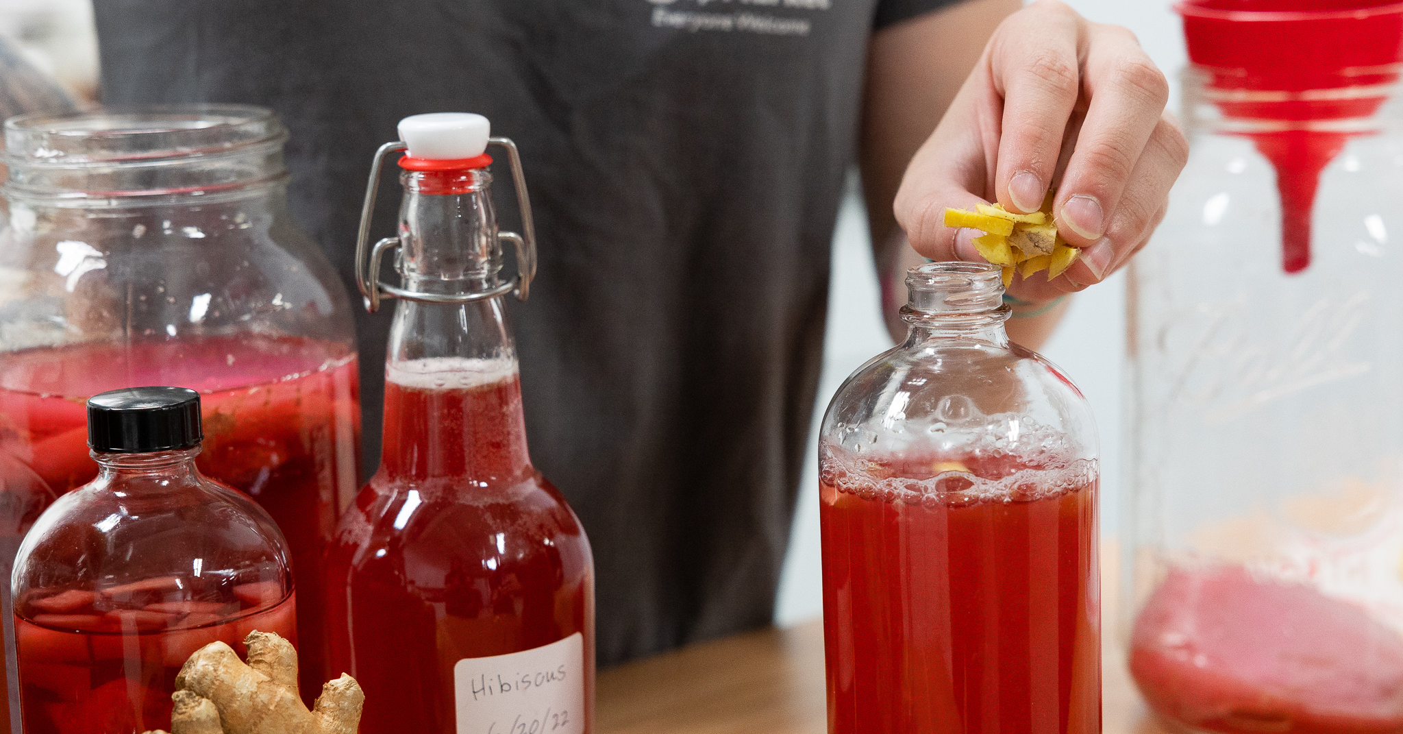 putting ginger into a kombucha bottle