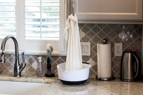 Hanging Butter Muslin filled with the Cultured Milk over a bowl