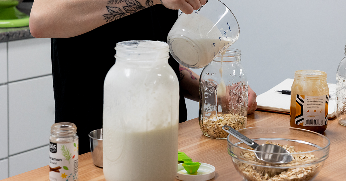 someone pouring milk into a jar
