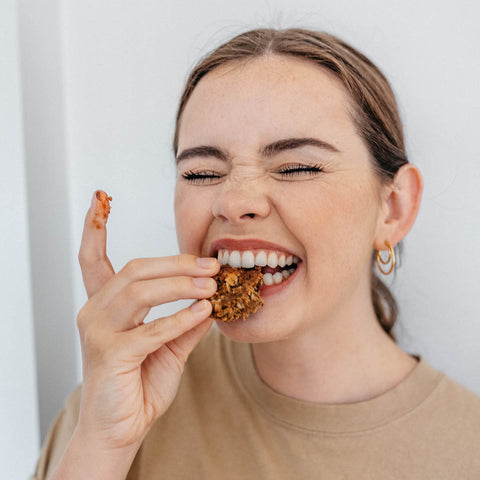 woman eating Maxine's Heavenly cookies