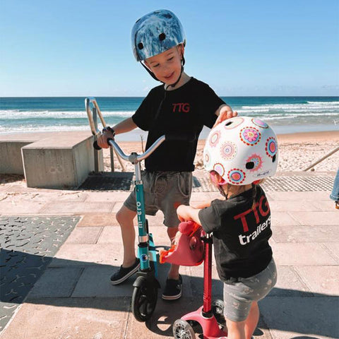 micro ambassador sophs' kids riding their scooters at the beach