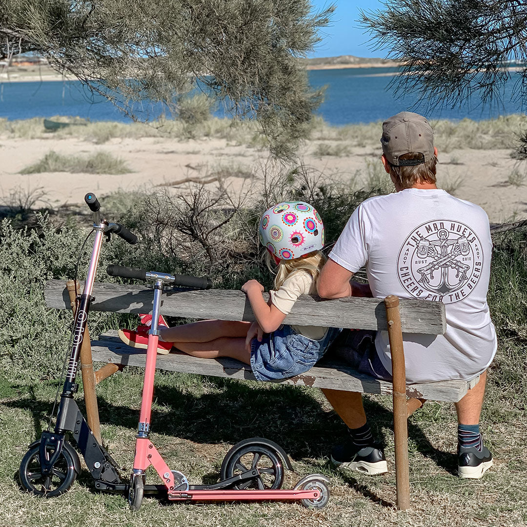 Dad and daughter having quality time with their scooters