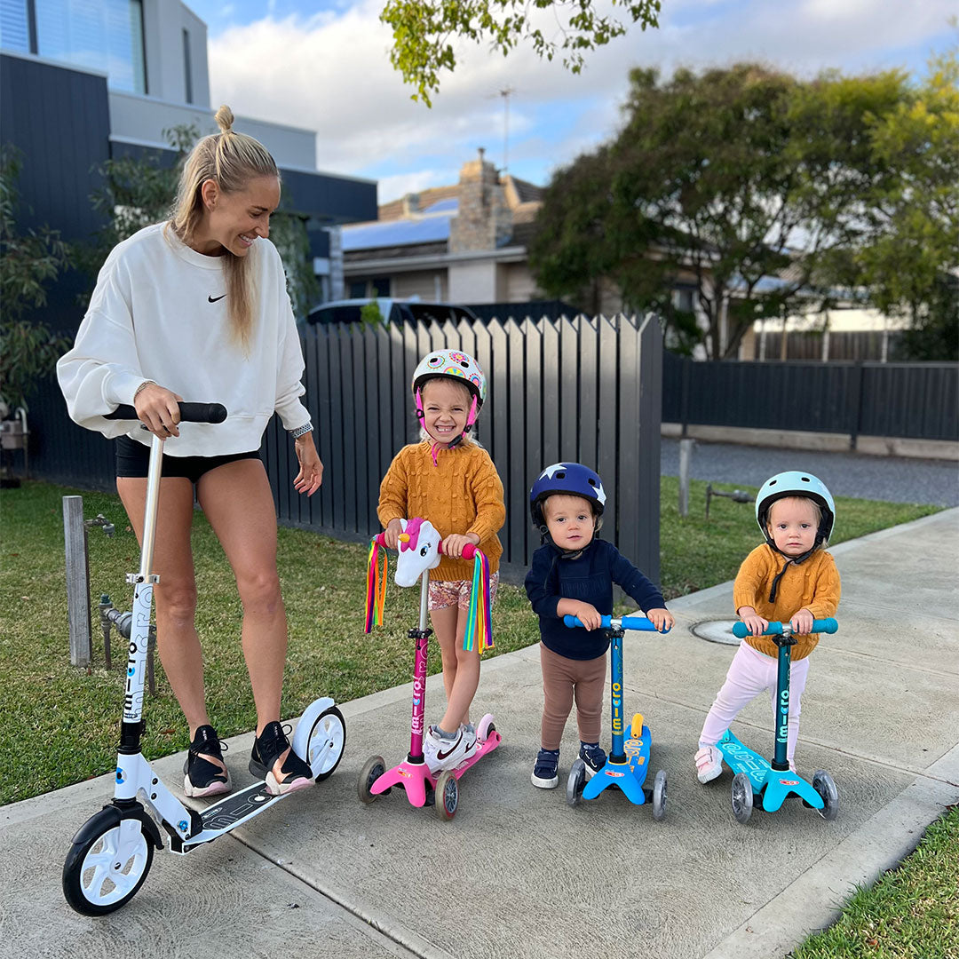 mum and her kids having fun on their scooters