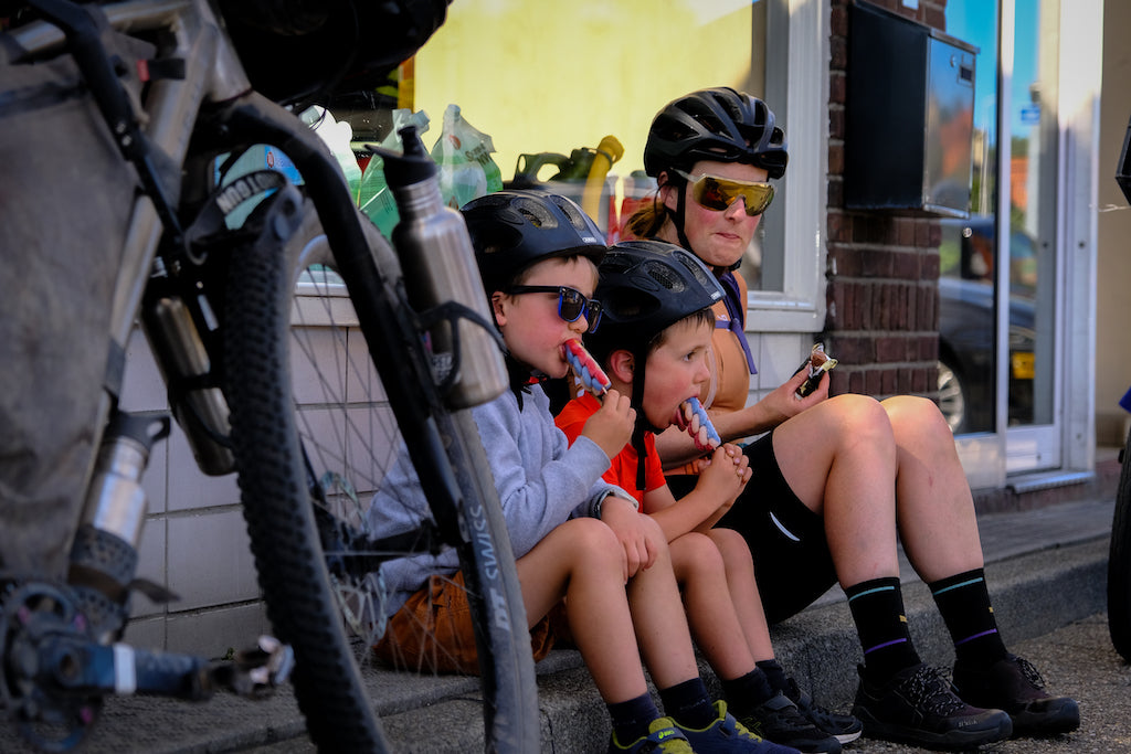 Mountain bike family eating icecream during a pit stop