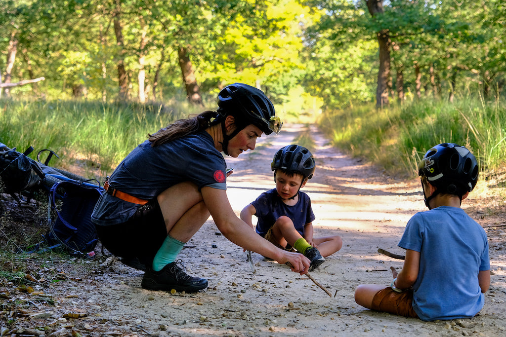 Mountain bike mum playing with her kids on the trail
