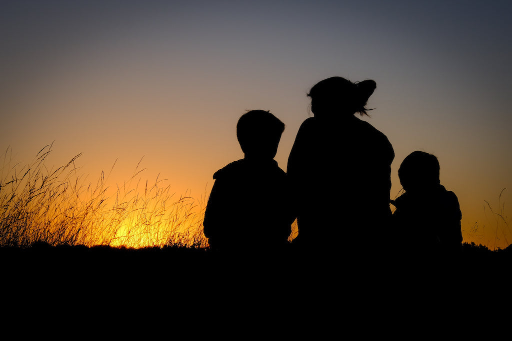Mum and sons watching a sunrise