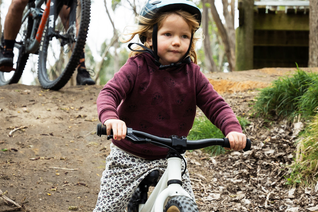 Off road balance bike kid using hand brakes