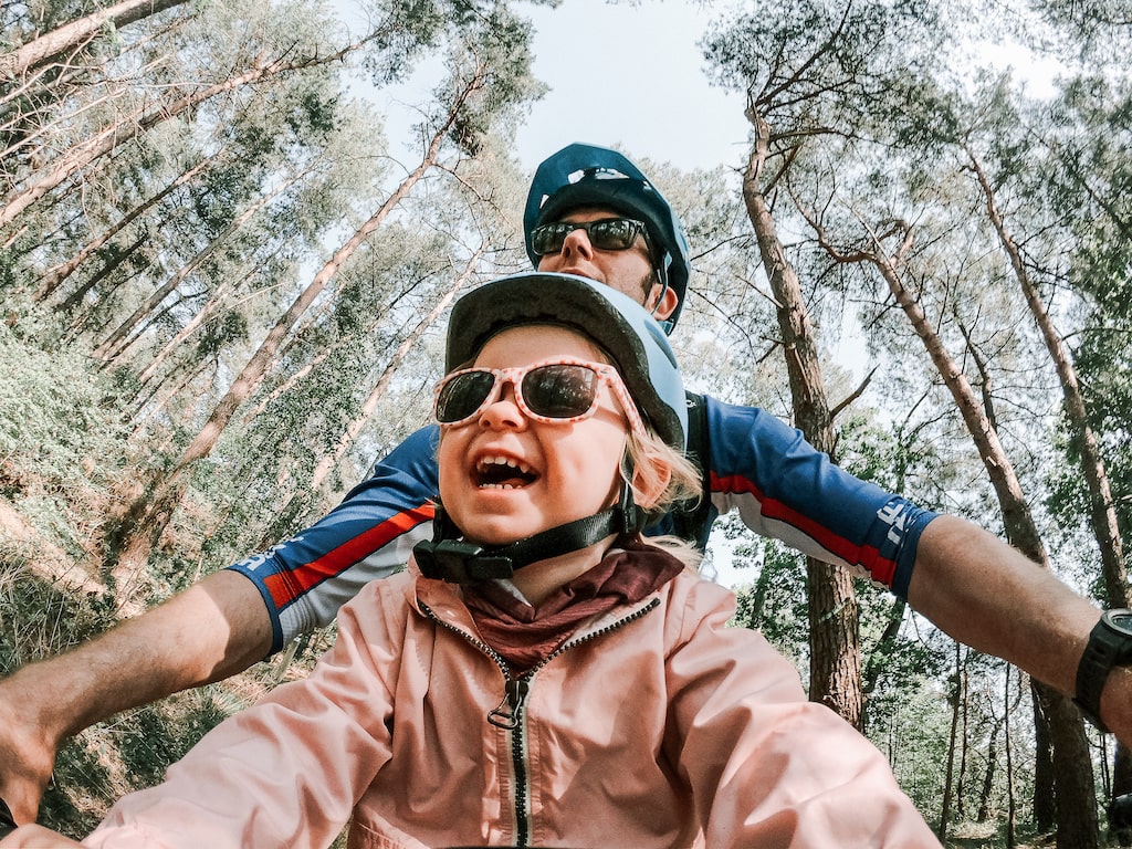 dad and daughter mountain biking together