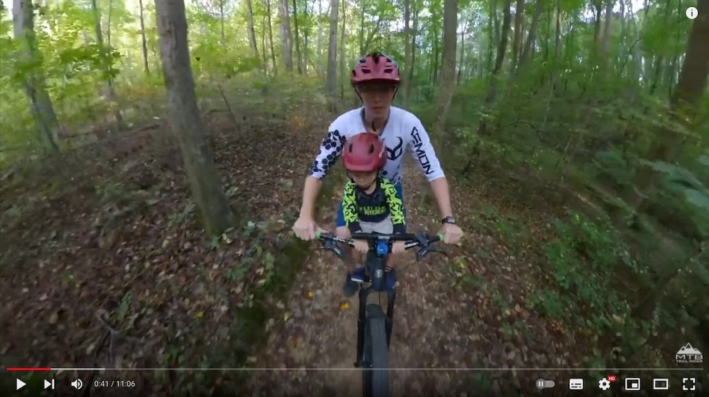 dad and son mountain biking together