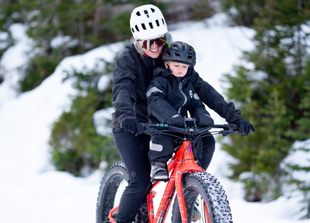 mum and son fat biking together in winter 