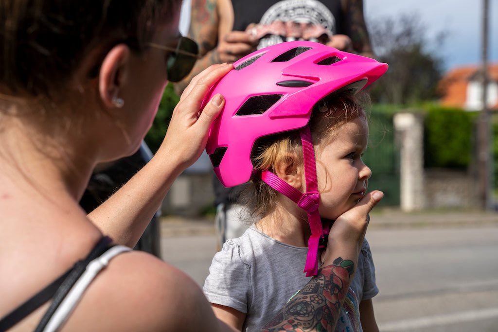 mum fitting daughters helmet