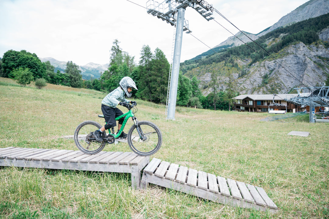 young boy downhill mountain biking in france