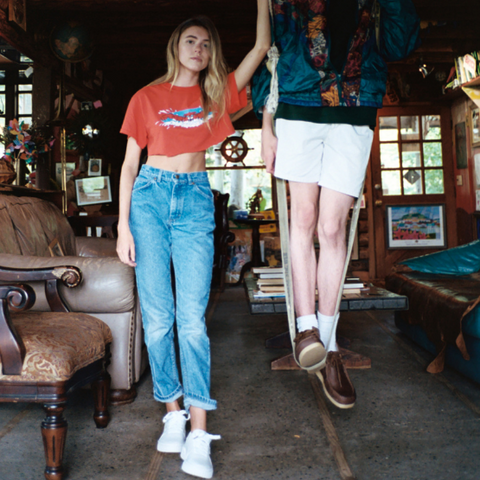 A woman in jeans and a cropped t-shirt