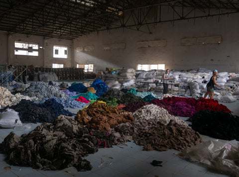 effects-of-fast-fashion-warehouse-full-of-textile-and-clothing-waste