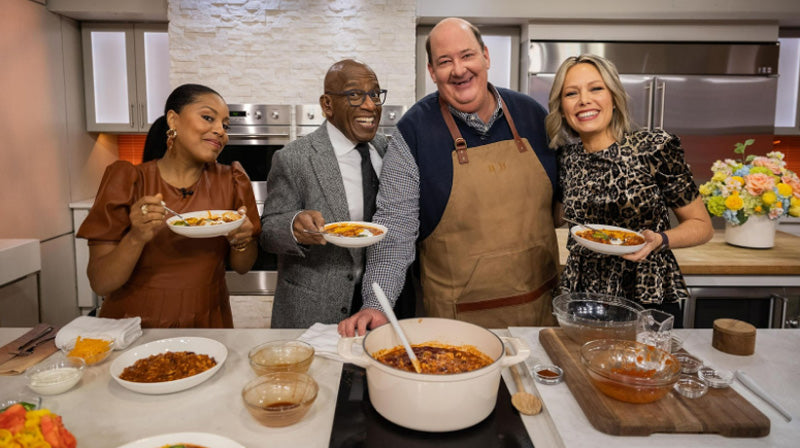 Brian Baumgartner and the hosts of the Today Food Show holding bowls of Kevin’s signature chili sauce
