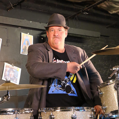 Brian playing drums in a Scrantonicity tee