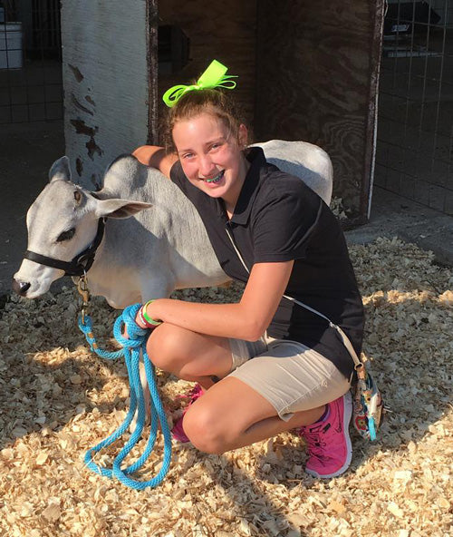 girl posing with mini Zebu