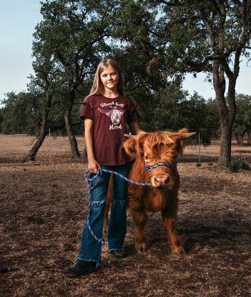 tiny cow sidled up next to gal