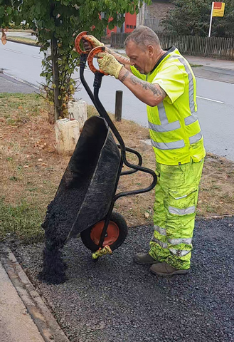 Workmen over 50 using iTip Handles on a wheelbarrow