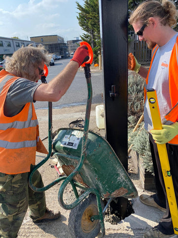 Two men installing a fence using Safety Handles