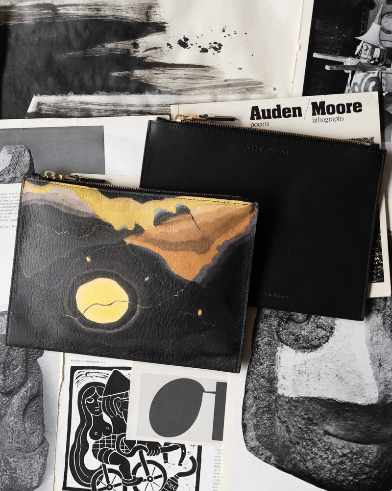 Unusual bag with Arthur Dove 'Me And The Moon' artwork arranged with art books.