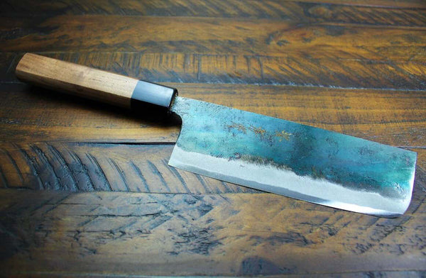 Blue Steel Nakiri Knife With Brown Handle on Dark-Wood Board