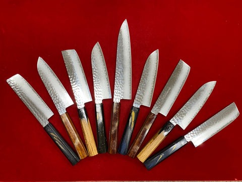 Nine Japanese knives lined up together