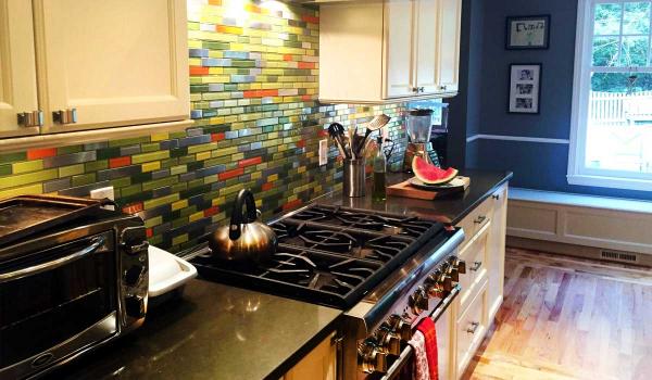 Steel Bamboo Remix With Orange, Yellow, and Grey Glass Tile Kitchen