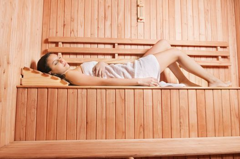 a woman lying inside a sauna