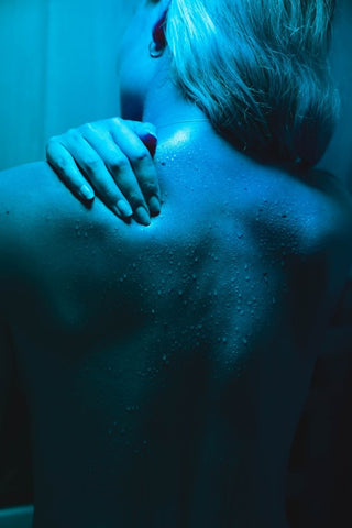 A woman sweating after a sauna session at home.