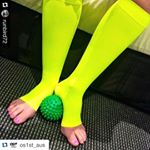 A pair of legs wearing neon yellow FS6+ Performance Foot and Calf Sleeves.