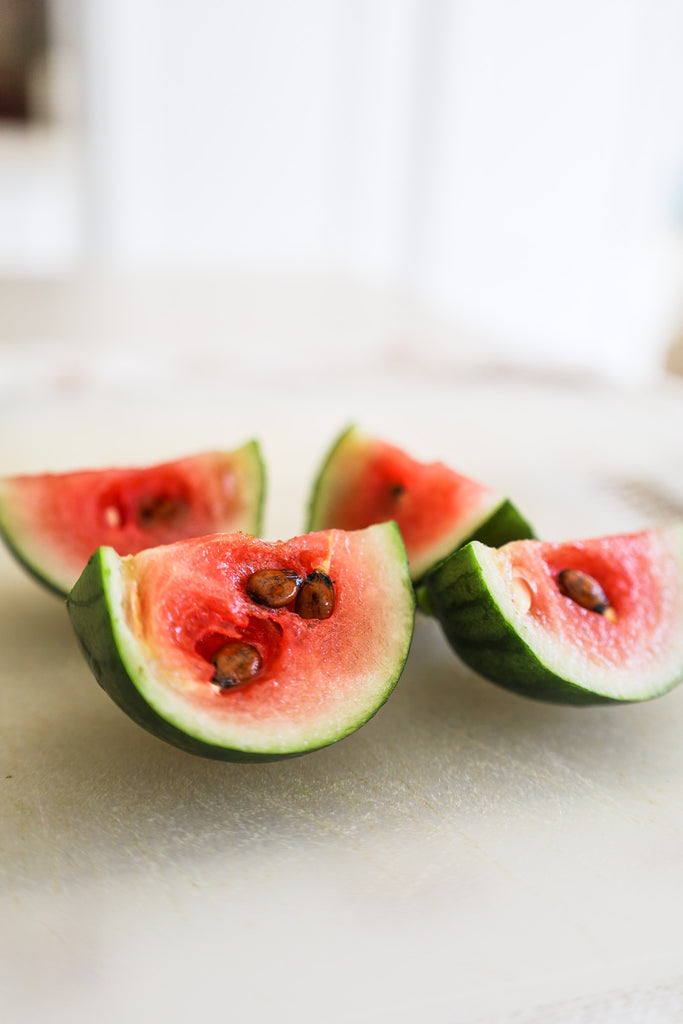 mini watermelon with full grown seeds on kitchen counter