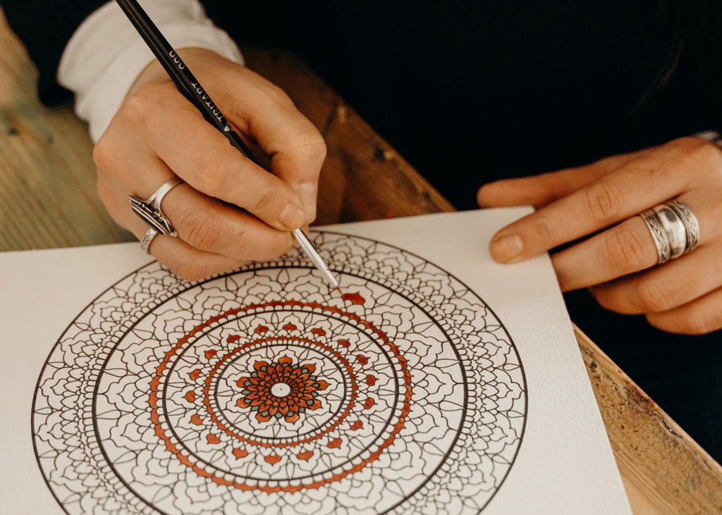 Painting to combat stress: woman painting mandala