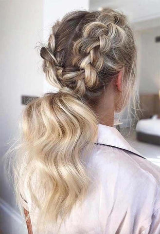 Girl with 2 double dutch braids leading down to a full and curled pony tail. She is facing away, so that you can see the whole hairstyle.