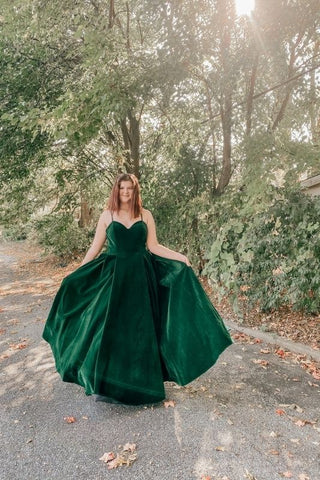 girl outside in her prom dress taking pictures