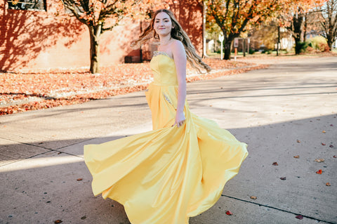 girl wearing a yellow ball gown