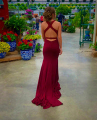 Girl walking away in her red prom dress. The back of her dress has a lot of straps, so her hair is in an updo.