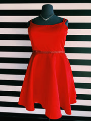 Image of the dress described in the post. It's a plus size, red A-Line short dress with beaded waistline. It is on a black mannequin, in front of XO's striped wall.