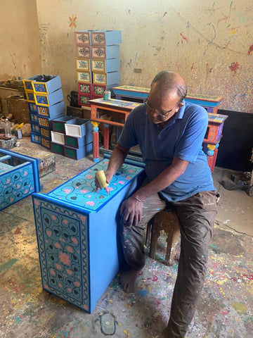 artisan painting coffee table by hand