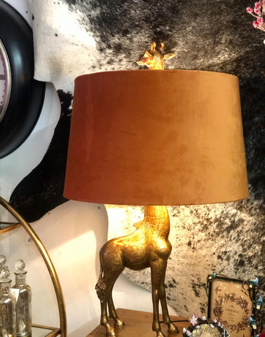 gold giraffe with orange velvet shade