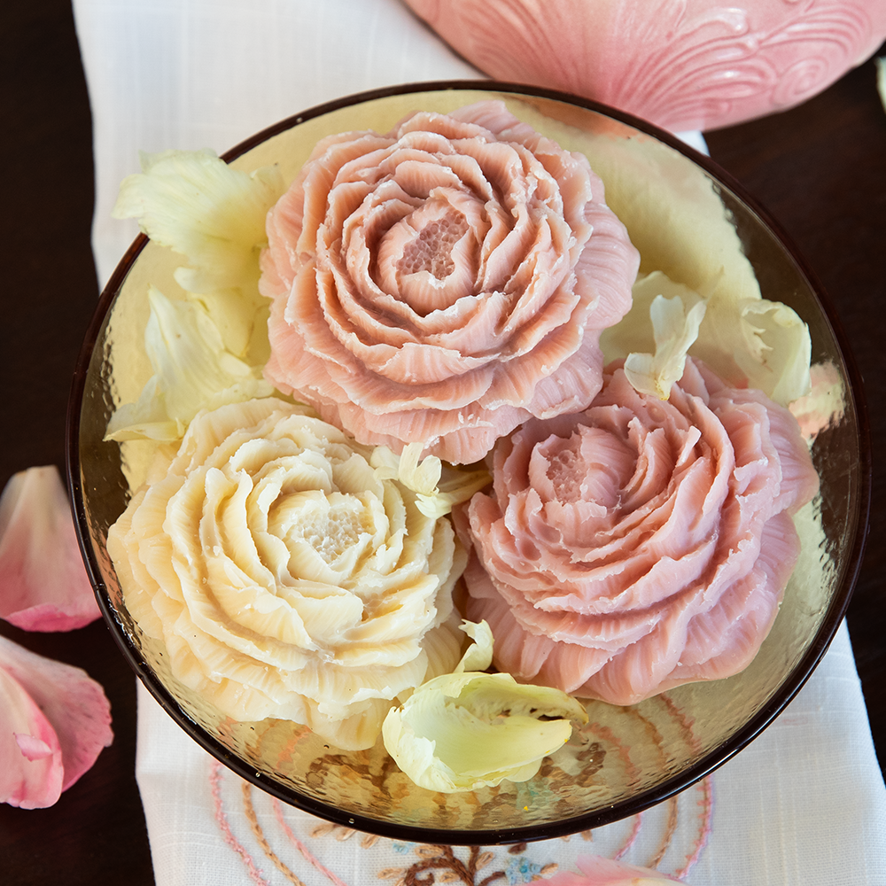 three peony shaped soaps in a bowl