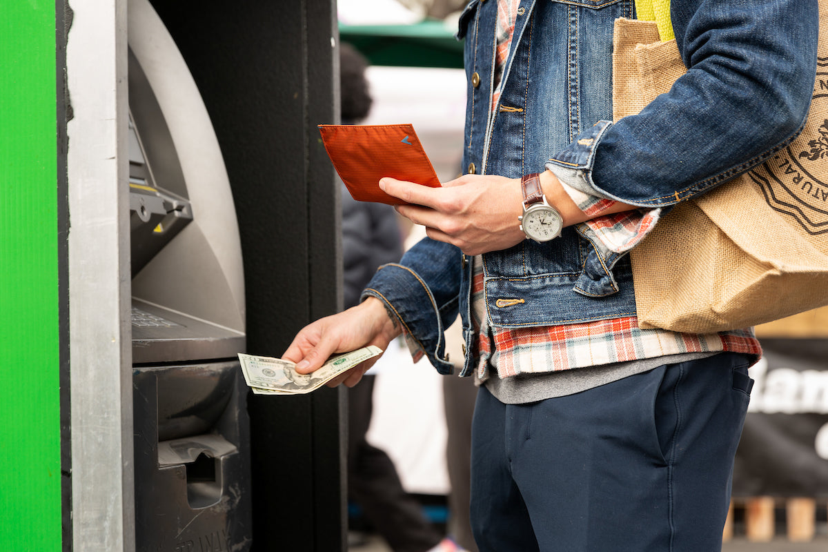 Man at ATM with a Allett Wallet