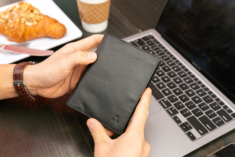 Man holding the Allett Leather Coin Wallet 2.0 showing the exterior leather details