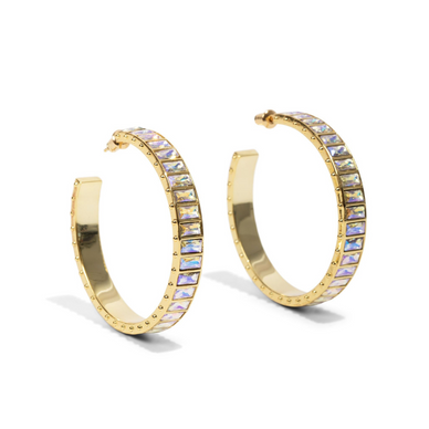 Turn heads this holiday with our Large Eternity Gem Hoop in our Iridescent Crystal Stone Color way. Perfect for party season, these epic earrings are made for celebrating. 
*Sold as a pair 
Measurement: 45mm 
Metal + Materials: 14k gold plating over brass, Swarovski gems circle the entire hoop 
Fulfilled by our friends at Short Suite 

*Please Note: 

This item is not eligible for returns 
This item cannot be shipped outside the U.S.
