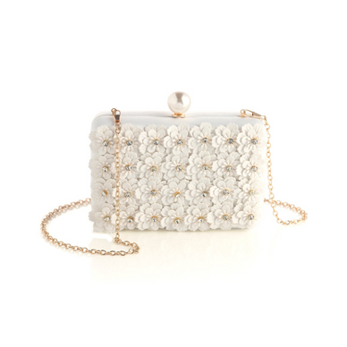 Bring blooming flowers along wherever you go with Shiraleah's Fiorella Minaudiere. This elegant white purse is decorated with flower rhinestone embellishments with a classic faux pearl top clasp. You can carry it like a clutch or use the detachable cross-body chain for some extra versatility in your style. Pair with other items from Shiraleah to complete your look! 

Features a detachable cross-body chain and a magnetic frame closure
Shiraleah is a trend-driven lifestyle brand focused on the little gifts that make life special!
Made from polyester and faux pearls, with gold hardware
Measures L 7" x w 2" x h 4.5"; chain 23"
Made in China

Fulfilled by our friends at Shiraleah 
*Please Note: 

Rewards cannot be applied to this product
This item is not eligible for returns 
This item cannot be shipped outside the U.S.
