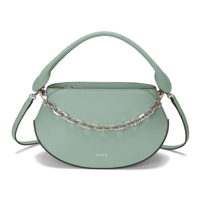 The Flor Mini Handbag is versatile and ideal for summer night outs and casual strolls. Whether you're attending a social event or taking a leisurely walk, this bag is designed to complement your style and add a trendy flair to your look. 
The bag comes with a detachable leather strap, providing flexibility in how you carry it. You can wear it with the leather strap for a classic and sophisticated look or without it for a sleek and minimalist appearance. 
In addition to the leather strap, the Flor Mini Handbag features a trendy chain short strap. This strap adds a touch of edge and fashion-forward flair to the bag's design, making it a statement piece for your summer outings. 


Mint: Mint is a fresh and calming color that captures the essence of spring. It adds a pop of pastel color to your ensemble, making it suitable for those who appreciate a playful and trendy look. 


Material:  Leather 
Measurements: 
Dimensions: 8.5 x 5.8 x 4 in Strap Length: 40-46.5 in 
Fulfilled by our friends at FutureBrandsGroup 
*Please Note: 

Rewards cannot be applied to this product
This item is not eligible for returns 
This item cannot be shipped outside the U.S.


