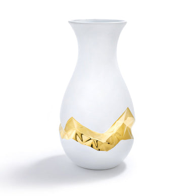 Our Oro vase is designed to celebrate the "beautiful imperfection" in all of us. To manifest the idea of accepting ourselves exactly as we are, our first collection carves proprietary algorithmic patterns into the sides of vases, bending the notion of "perfection". This vase continues our exploration into biomorphic design: the algorithmic pattern we created is a 3D mathematical pattern inspired by principles found in nature. The result is exquisite porcelain objects which are recognizable as vases, hold flowers with grace, and are simultaneously entirely unexpected. Hand-painted with 24K Gold, they are each as unique as we are. 

Ceramic and 24K Gold
Imported
Wipe clean with damp soft cloth.
5" x 5" x 12"

Fulfilled by our friends at ANNA NEW YORK 
*Please Note: 

Rewards cannot be applied to this product
This item is not eligible for returns 
This item cannot be shipped outside the U.S.

