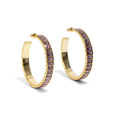 Turn heads this holiday with our Large Eternity Gem Hoop in our Purple Stone Color way. Perfect for party season, these epic earrings are made for celebrating. 
*Sold as a pair 
Measurement: 45mm 
Metal + Materials: 14k gold plating over brass, Swarovski gems circle the entire hoop 
Fulfilled by our friends at Short Suite 

*Please Note: 

This item is not eligible for returns 
This item cannot be shipped outside the U.S.
